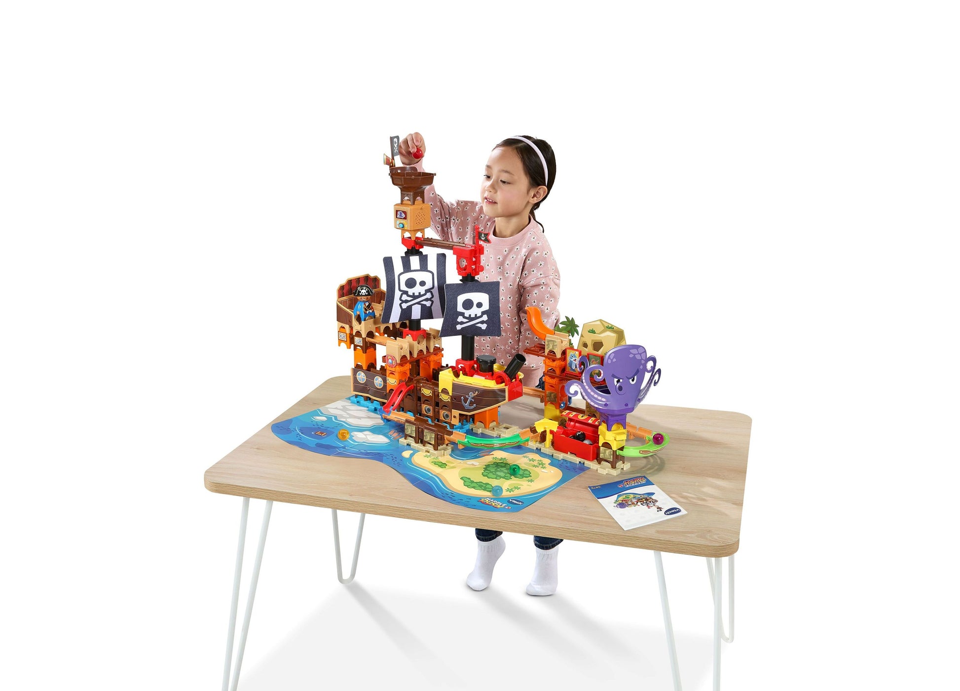 VTech Marble Rush Pirates Cove set with colorful pirate tower, tracks, and purple octopus piece on wooden table