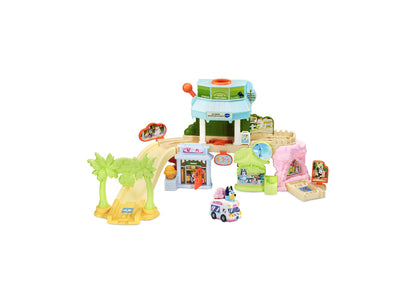 Bluey Ice Cream Adventure Playset with colorful buildings, palm tree, ice cream truck, and interactive SmartPoint fea...
