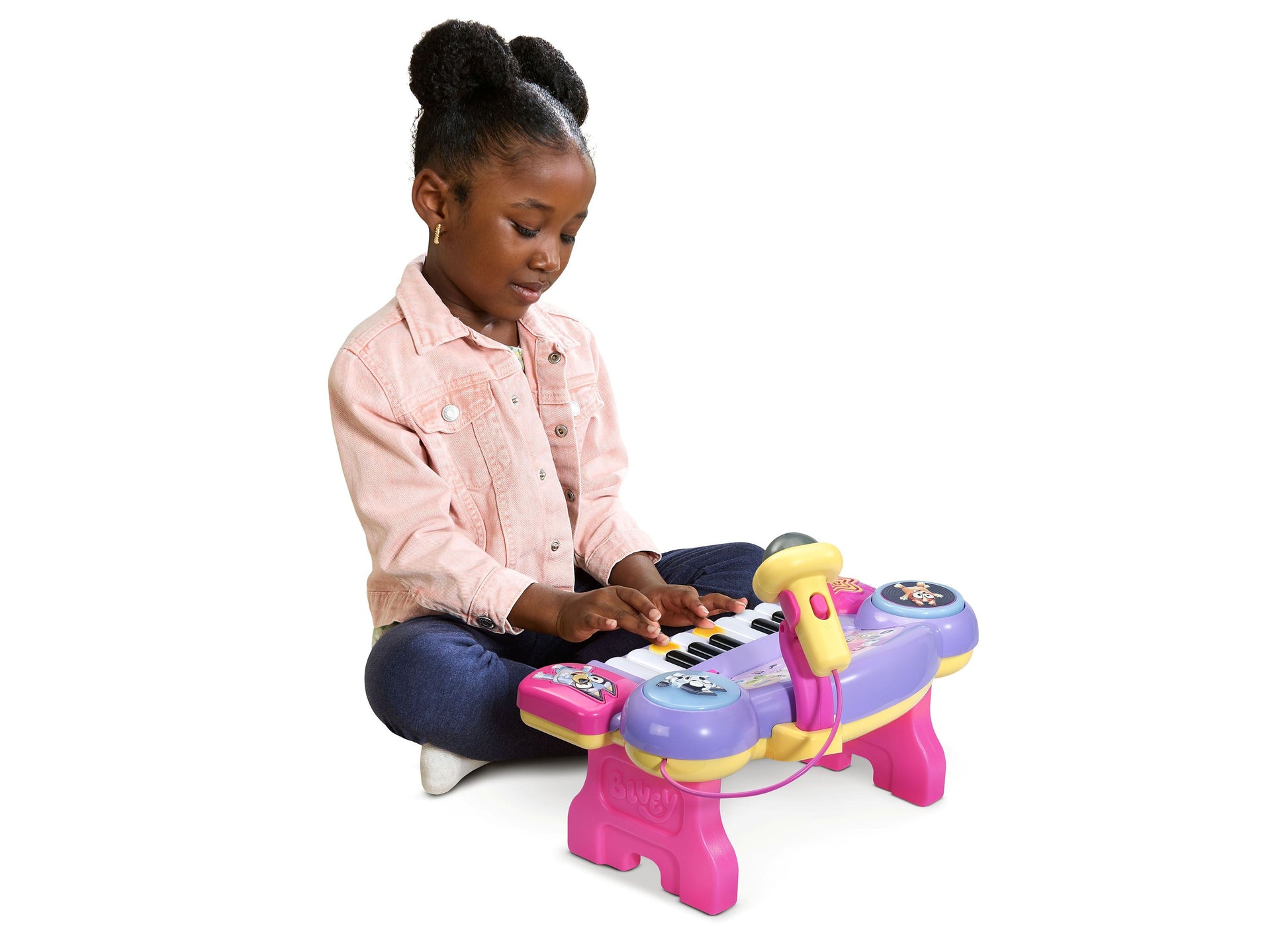 Bluey Sing-Along Keyboard in pink and purple with girl playing music