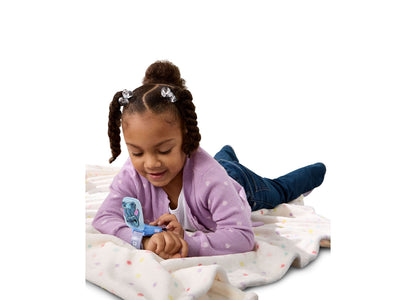 VTech Stitch Learning Wrist Watch in blue worn by young child playing on bed
