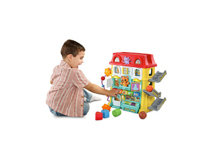 VTech Up & Down Activity Town colorful interactive learning center with red roof, yellow sides, and shape toys