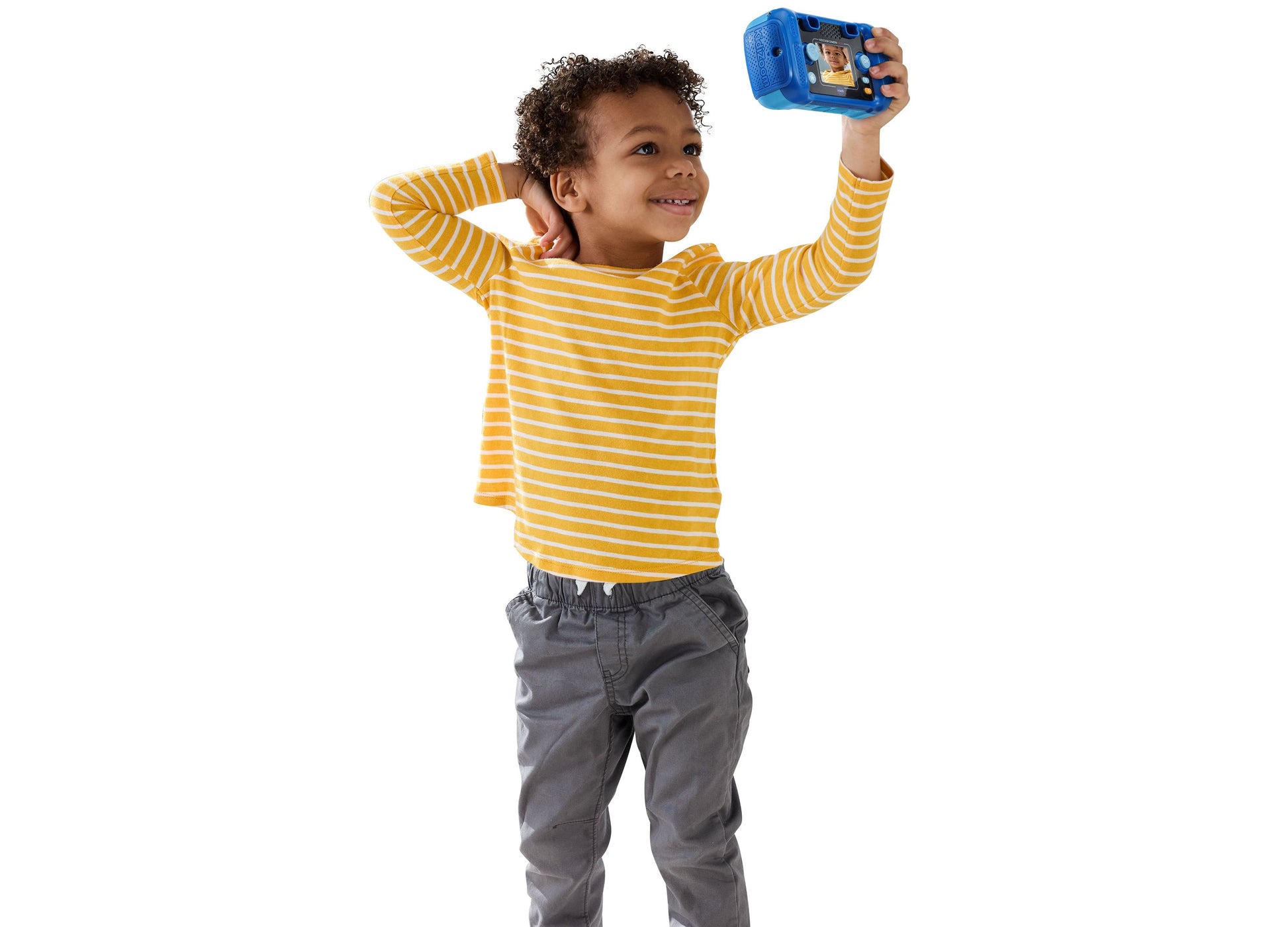 VTech KidiZoom digital camera in blue held by smiling child in yellow striped shirt