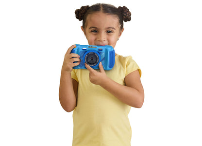 VTech KidiZoom blue digital camera with photo effects, held by young child in yellow shirt