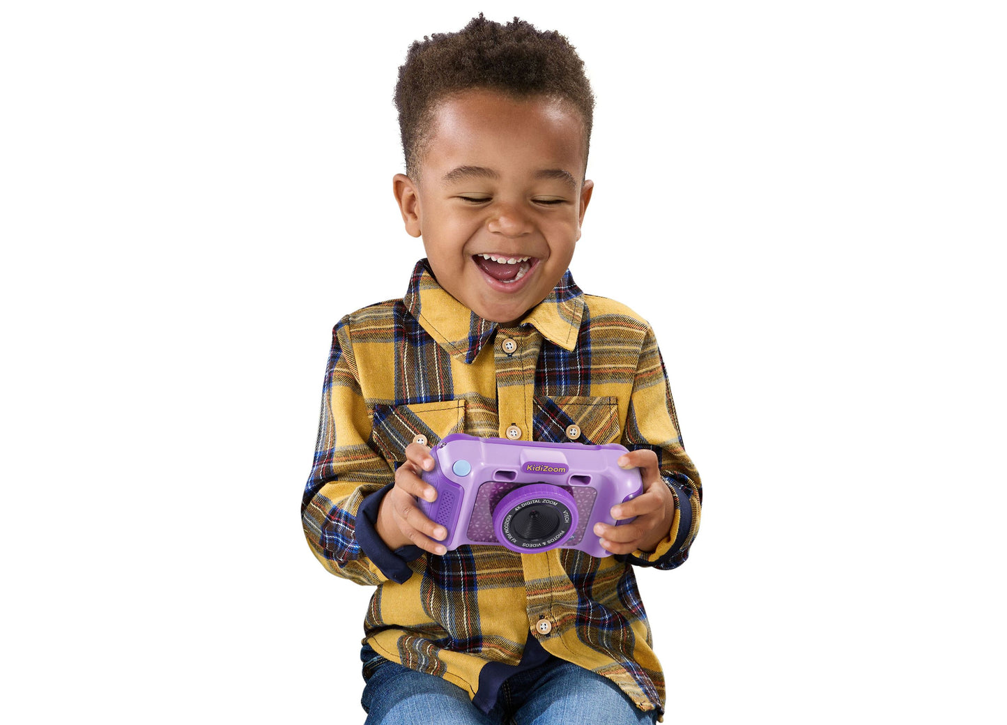 VTech KidiZoom purple digital camera held by smiling young child