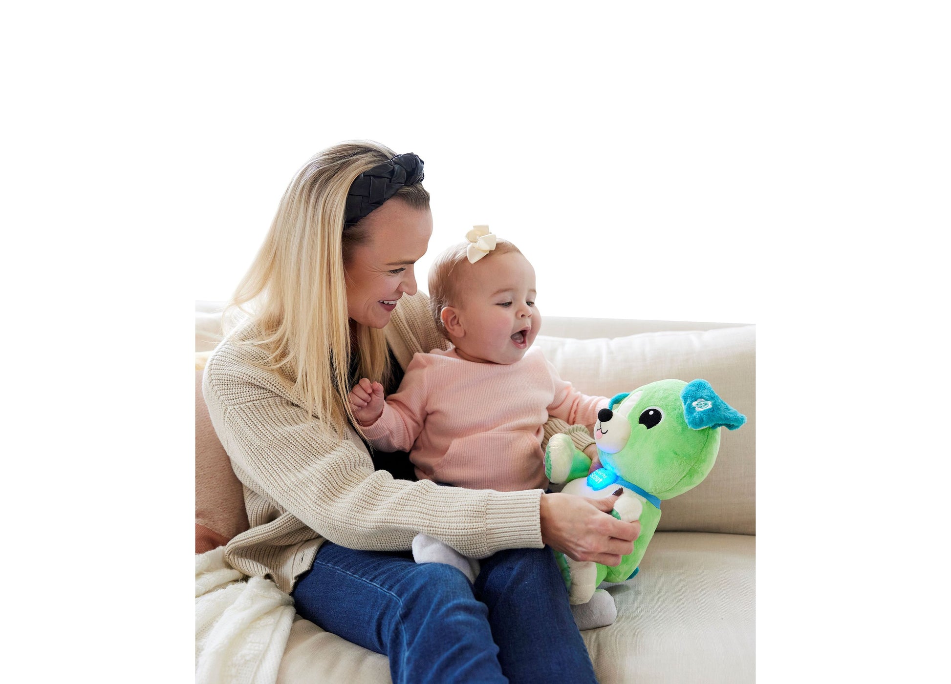 LeapFrog My Best Pal Scout green plush toy with blue accents being held by adult and baby