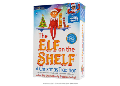 Elf on the Shelf Scout Elf Boy figure with storybook set in red outfit on shelf with Christmas tree and accessories