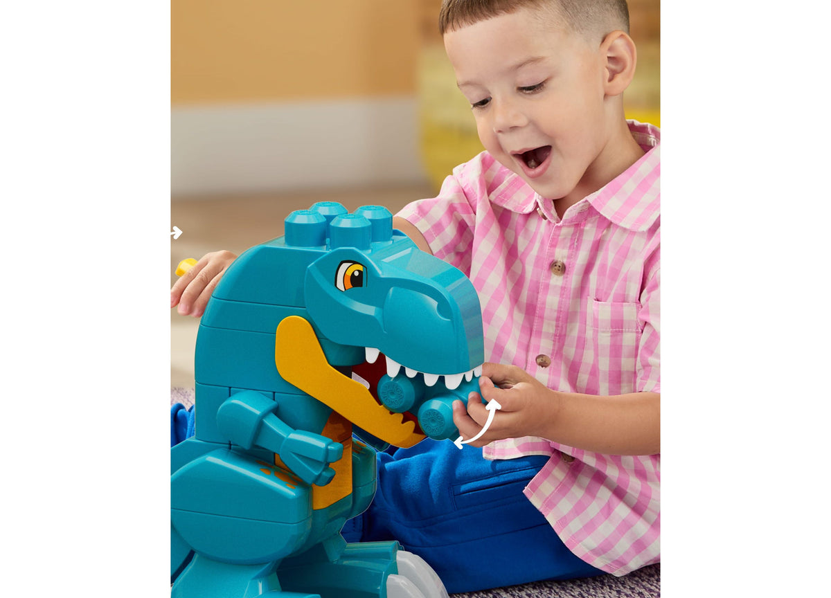 Turquoise Mega Bloks Build & Chomp Dinosaur set with yellow jaw, child in pink shirt playing with chomping T-Rex toy