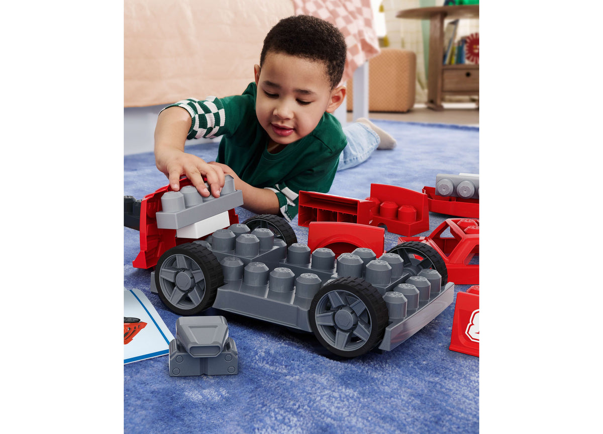 Child building red and gray race car with blocks and rolling wheels from Mega Bloks Build & Go 26-Piece set