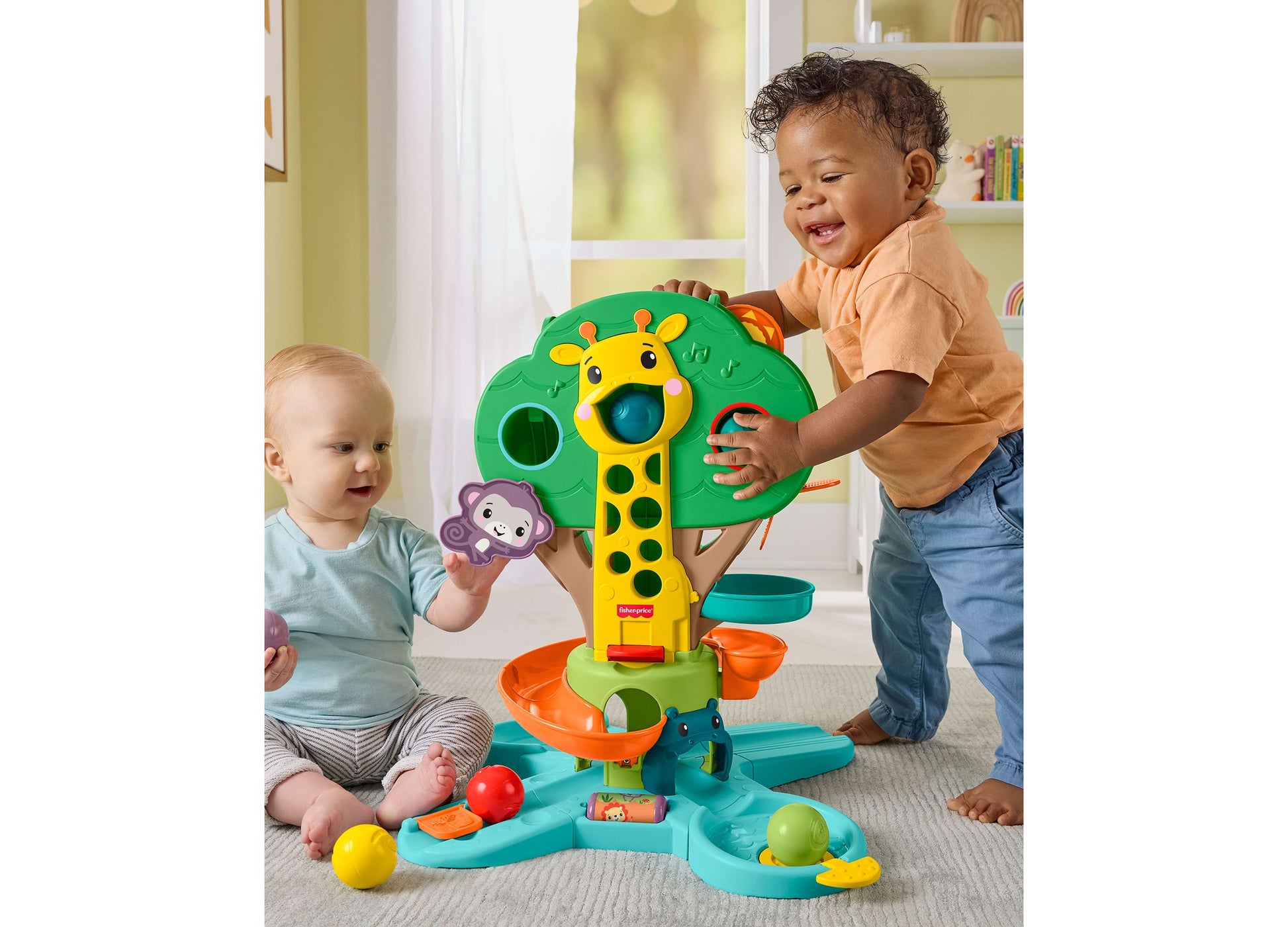 Fisher Price Jungle Tree Musical Ball Drop Activity Center with giraffe toy, colorful balls, and two toddlers playing