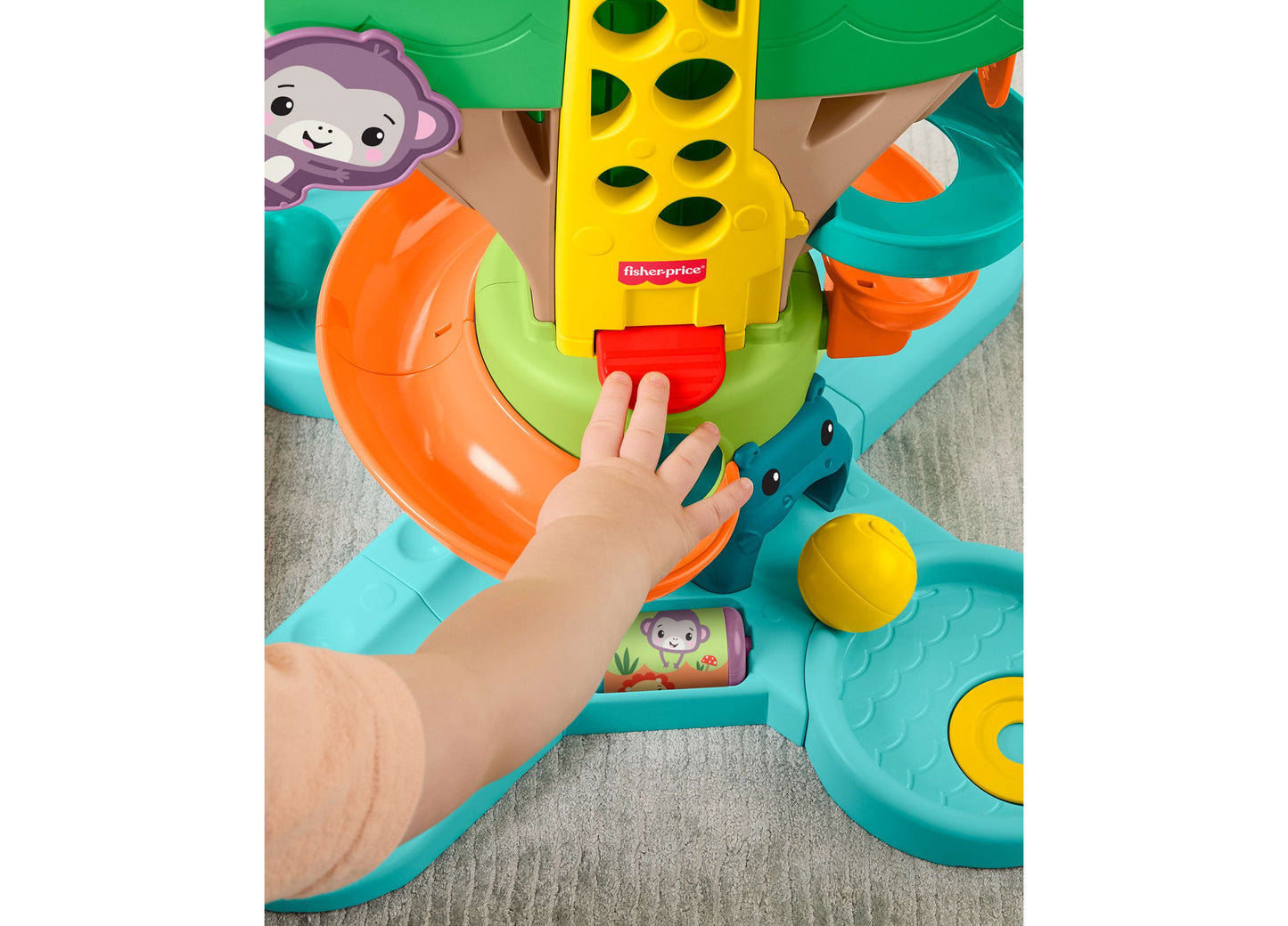 Fisher Price Jungle Tree Activity Center with baby's hand playing with yellow ball drop toy
