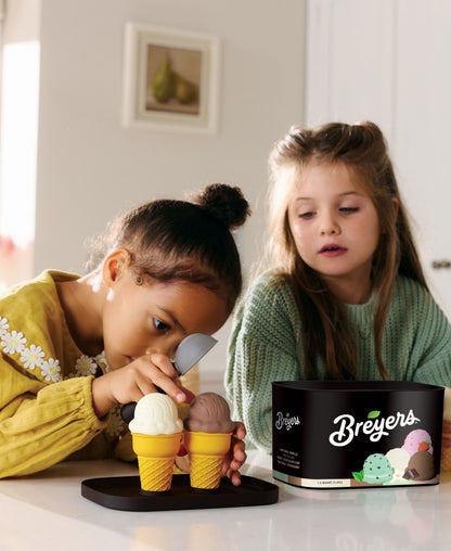 Casdon Breyers Ice Cream Scoop-and-Serve Playset with two children holding cone toys next to black branded tub