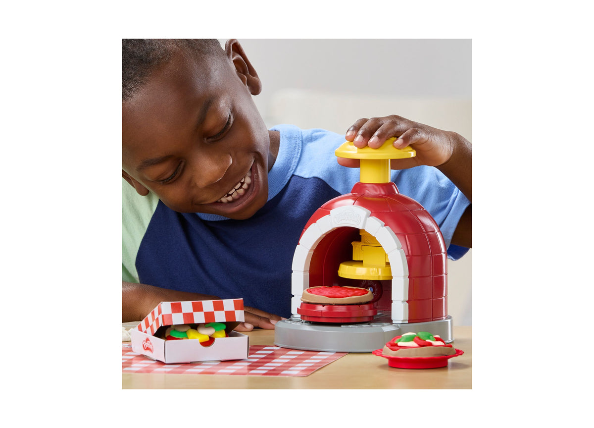 Child playing with Play-Doh Stamp and Spin Pizza Playset, red and yellow toy pizza maker with colorful dough