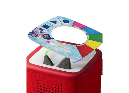 Tonies Guess Who Monster Mysteries colorful game disc with blue, red, yellow, and green sections on red speaker base