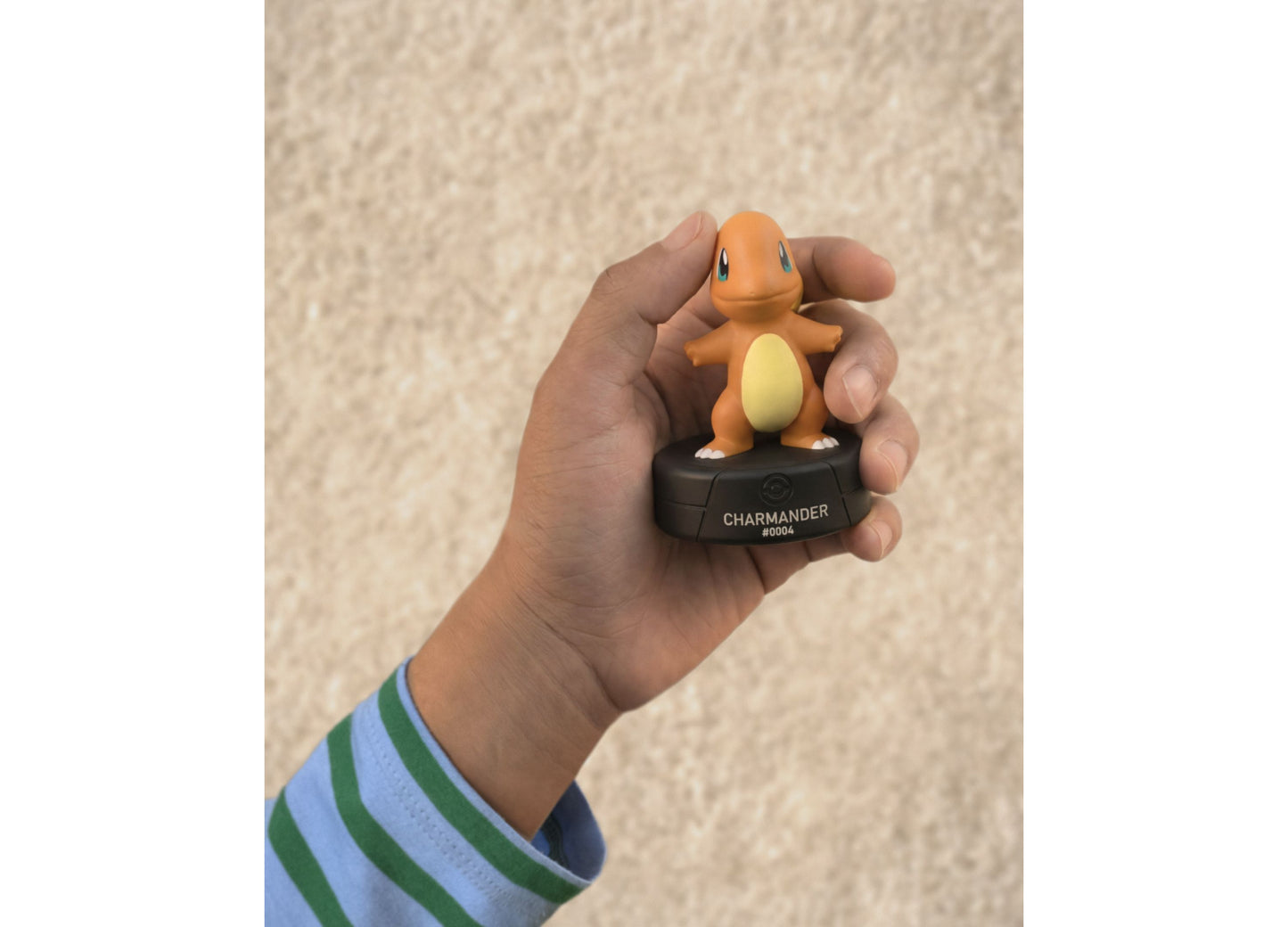 Charmander Tonie Pokemon figure with orange body and yellow belly held in hand