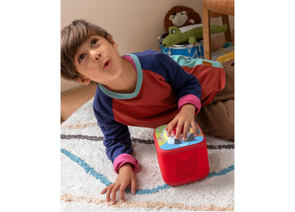 Tonies Tonieplay Bluey screen-free audio game in red, held by young child on carpet