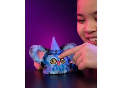 Blue Furby interactive plush toy with pointed ears, large yellow eyes, and red nose