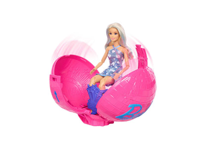 Barbie Roll & Reveal Pop Star doll with silver hair in blue sequin dress, seated in large pink spherical ball with bl...
