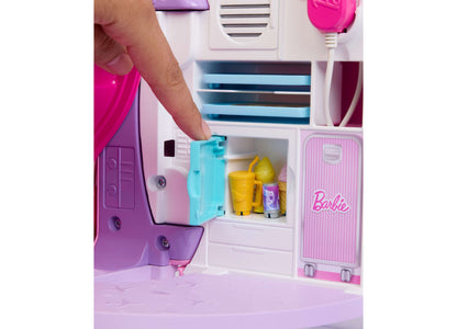 Barbie Dream Plane playset with pink and purple airplane, open door revealing yellow accessories, and child's hand in...