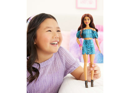 Barbie Fashionistas Style 250 doll with long reddish-brown hair, wearing blue snake-print off-shoulder dress and blac...