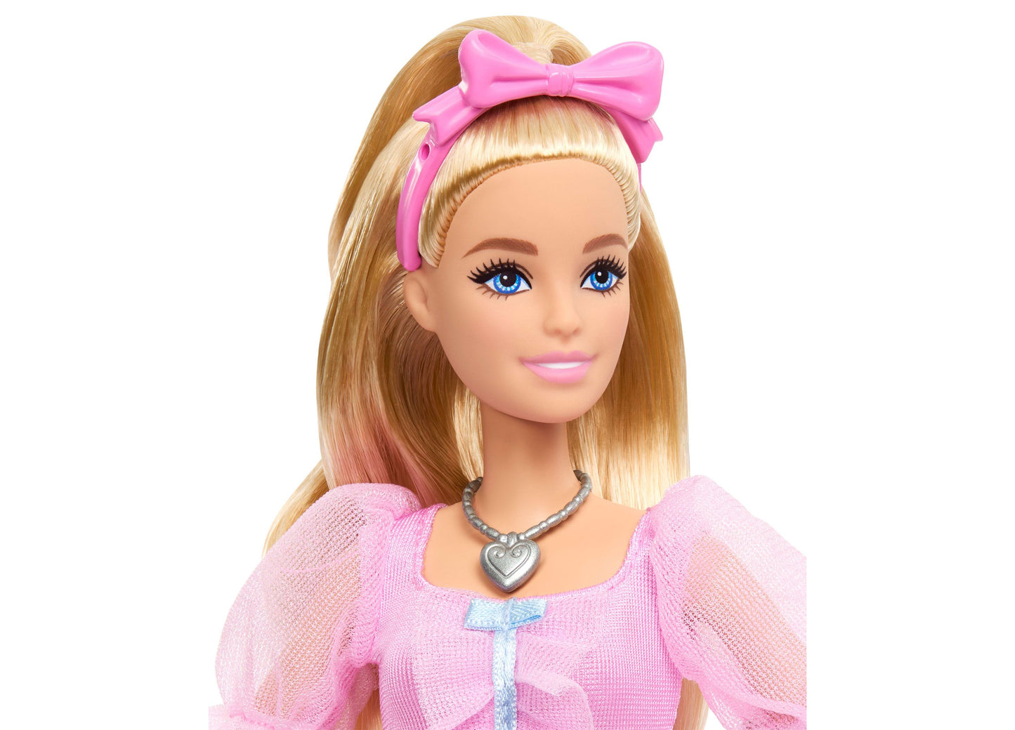 Barbie in the Nutcracker Clara doll with blonde hair, pink bow, pink dress, and heart necklace