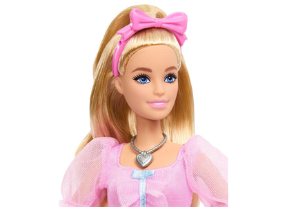 Barbie in the Nutcracker Clara doll with blonde hair, pink bow, pink dress, and heart necklace