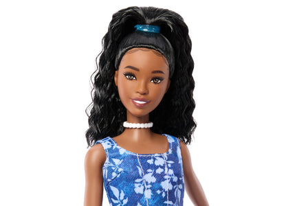 Barbie Fashionistas Style #248 doll with black wavy hair, blue headband, pearl choker, and blue floral dress