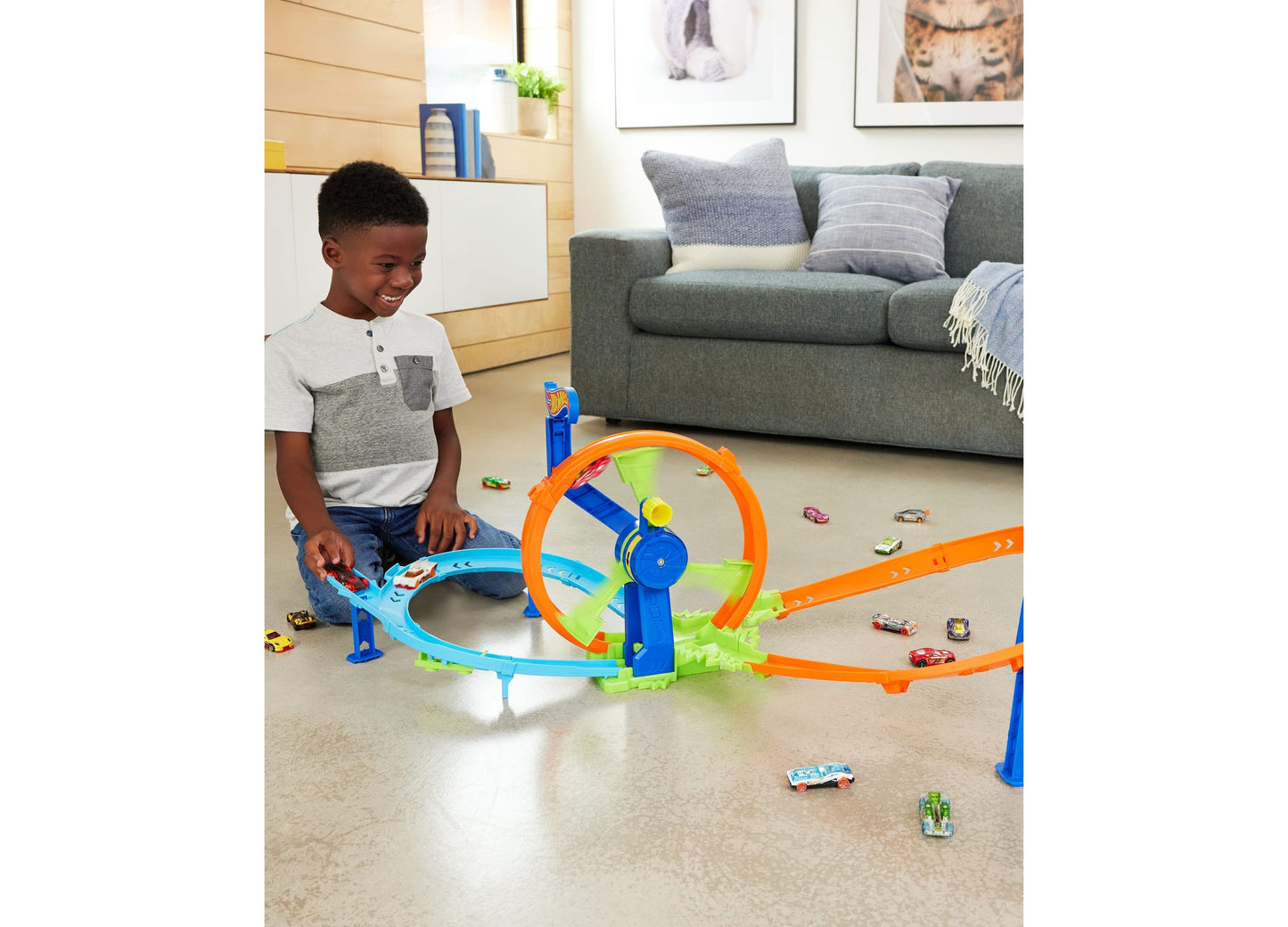 Hot Wheels Rapid Launch Loop Playset with blue and orange track, child playing with die-cast cars