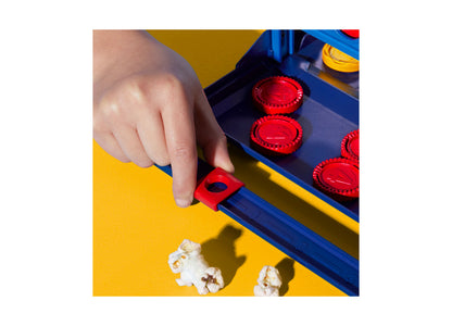 Hasbro Gaming Connect 4 board game with red checkers and blue-yellow board, child playing