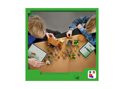 LEGO Minecraft Evoker Village Attack set with two children building orange and green structures on table