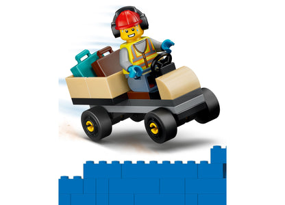 LEGO City Construction Worker minifigure in yellow vest driving tan cargo truck with blue suitcases