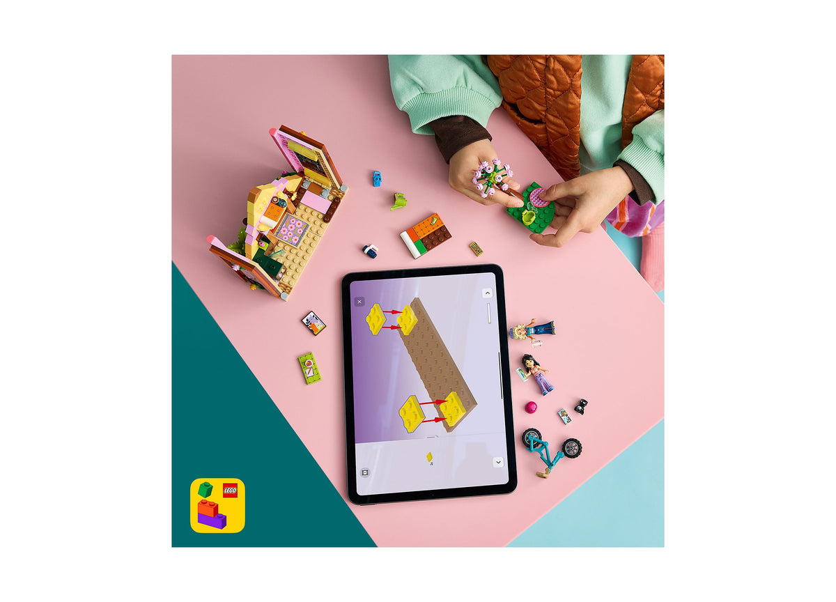 LEGO Friends Nature Glamping Cabin 42682 building set with colorful pieces and AR app on tablet