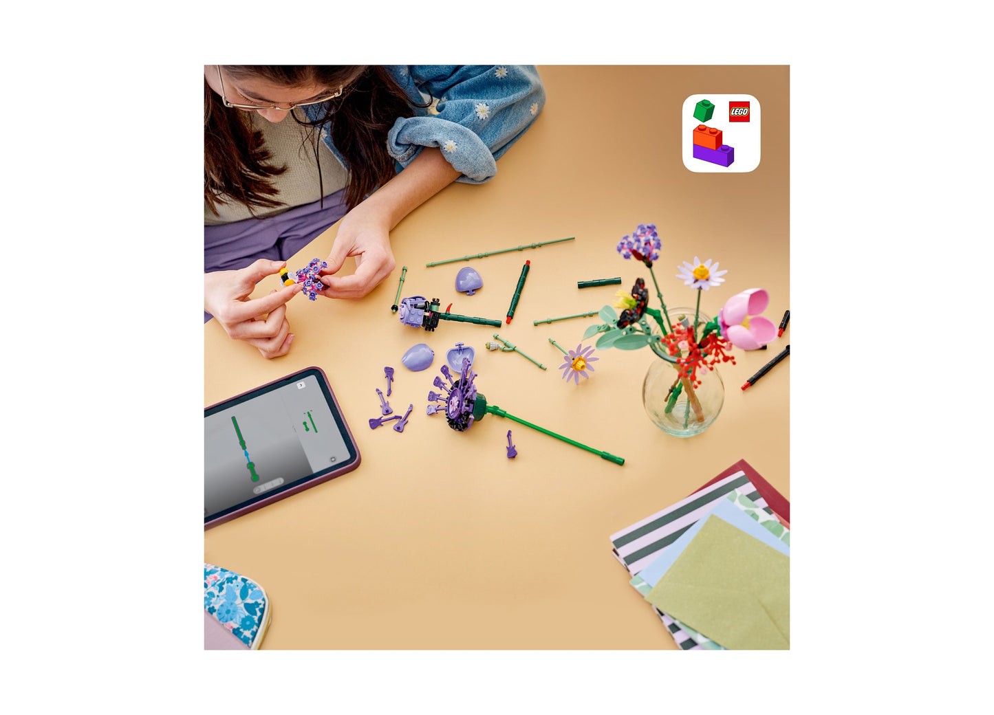 LEGO Olivia Rodrigo's Flower Bouquet set with colorful purple and pink flowers being built by child