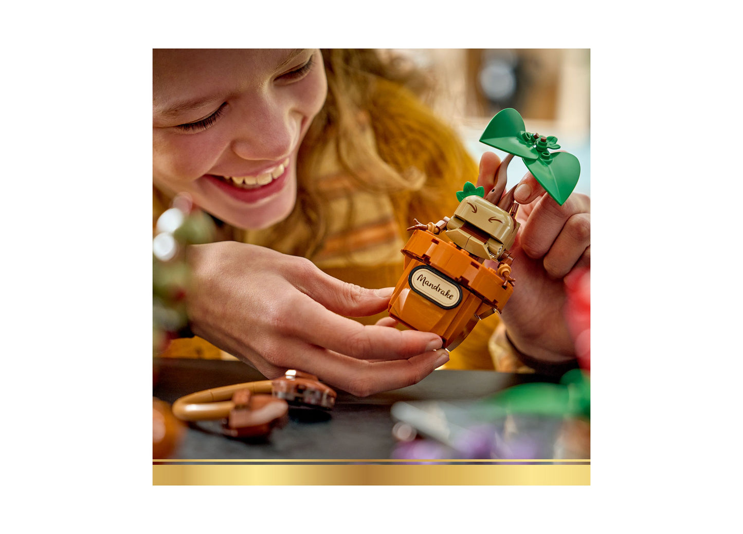 Child playing with LEGO Harry Potter Hogwarts Herbology Plants set featuring orange plant and green leaves