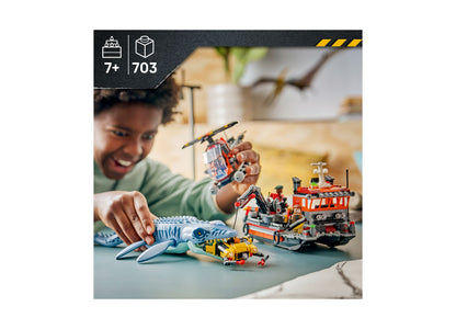 Child playing with LEGO Jurassic World Mosasaurus set featuring blue dinosaur, red boat, and yellow vehicle
