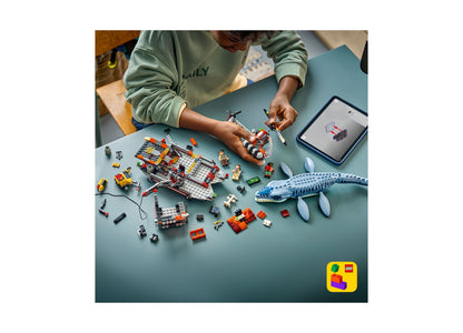 Child building LEGO Jurassic World Mosasaurus set with dinosaur, boat, and minifigures on blue table