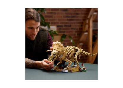 LEGO Jurassic World Triceratops fossil building set with tan skeletal model, display stand, and minifigure