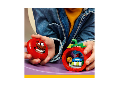 Child holding LEGO Fortnite Tomatohead 77079 red apple-shaped building set with green stem