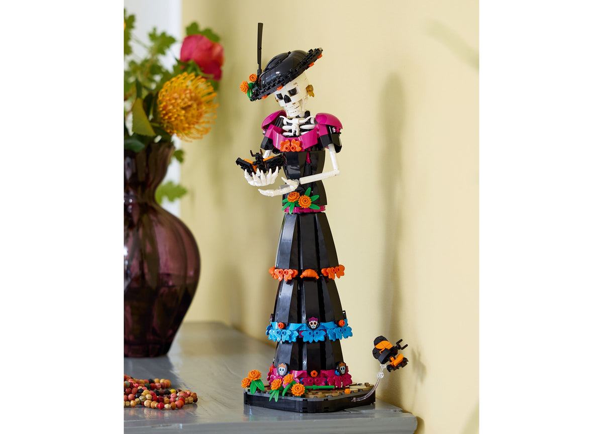 LEGO Ideas Day of the Dead La Catrina skeleton figure with colorful marigolds, magenta cape, and black hat