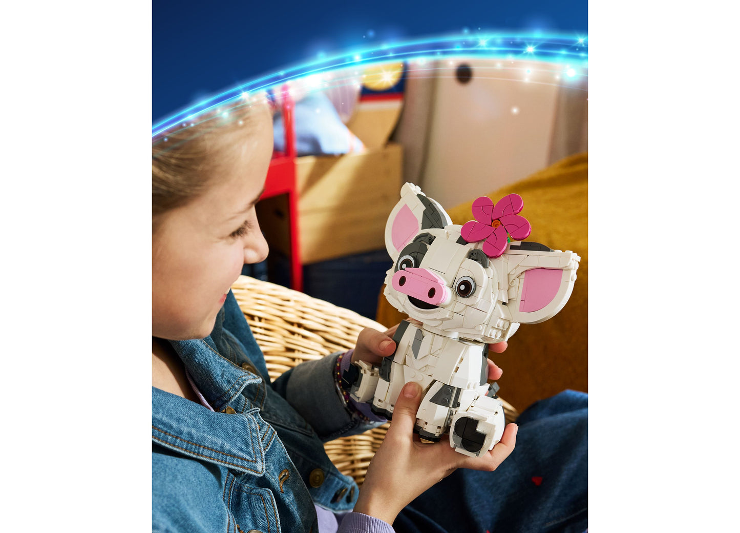 Child holding LEGO Disney Moana Pua building set with white and pink pig figure with flower