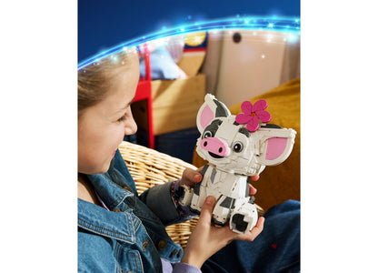 Child holding LEGO Disney Moana Pua building set with white and pink pig figure with flower