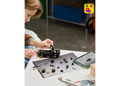Child assembling LEGO Ken Block's '65 Ford Mustang Hoonicorn V1 building set with black and gold pieces