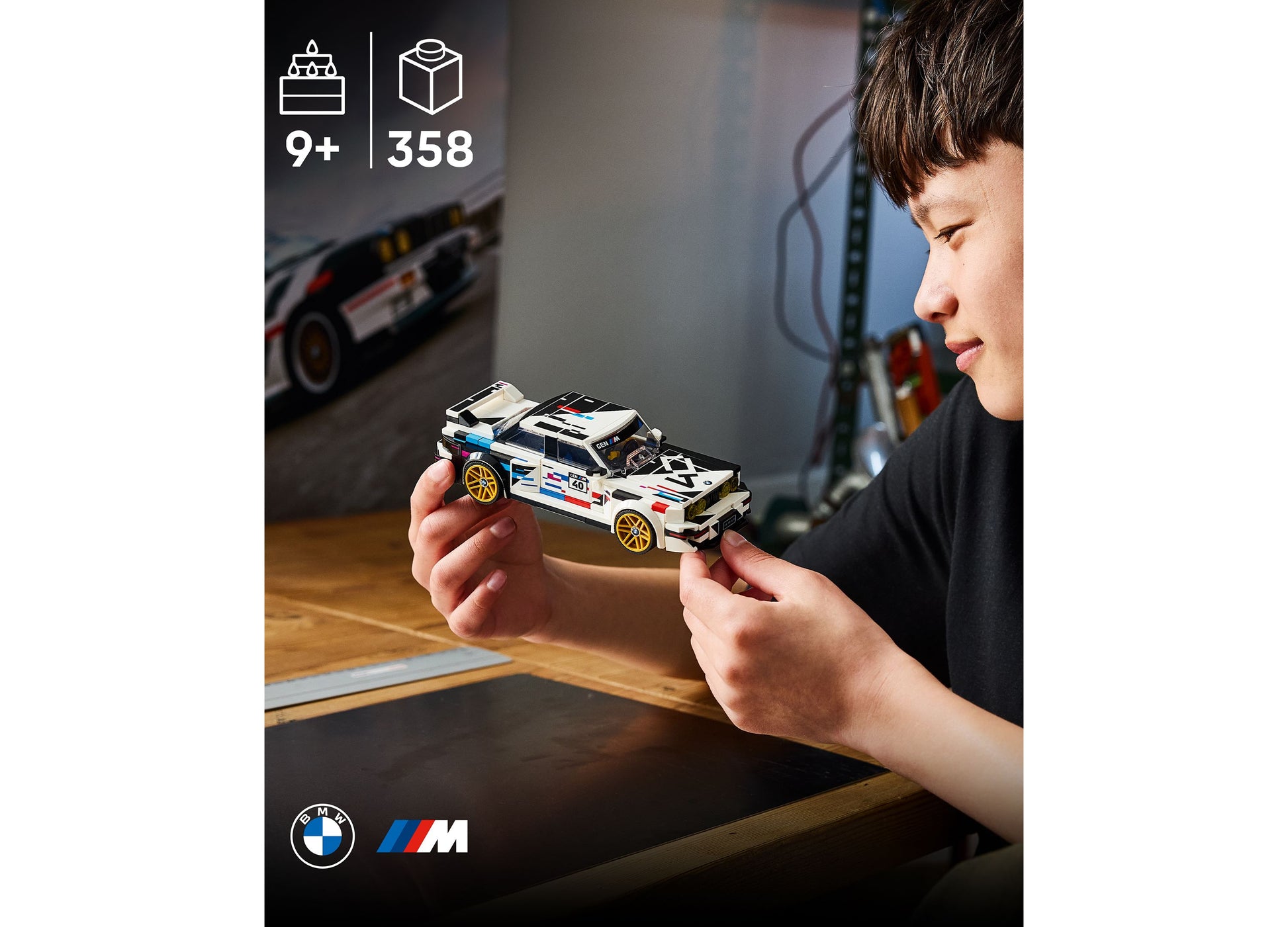 LEGO BMW M3 E30 white and gold racing car set held by child, 358 pieces