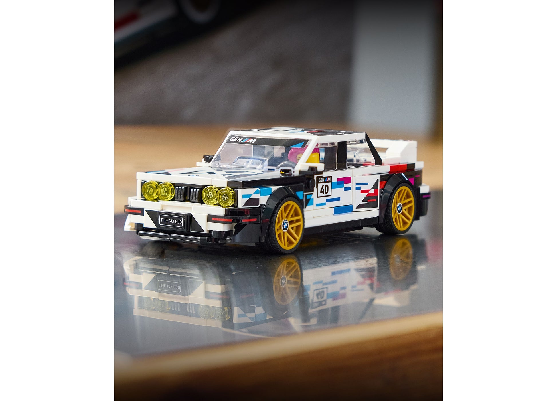 LEGO BMW M3 E30 white and black racing car with yellow wheels and colorful decals