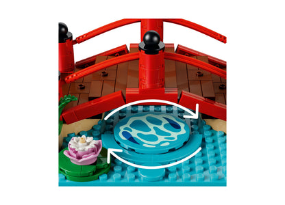 LEGO Animal Crossing 77059 set featuring red Japanese bridge, blue water pond, pink flower, and brown roof structure