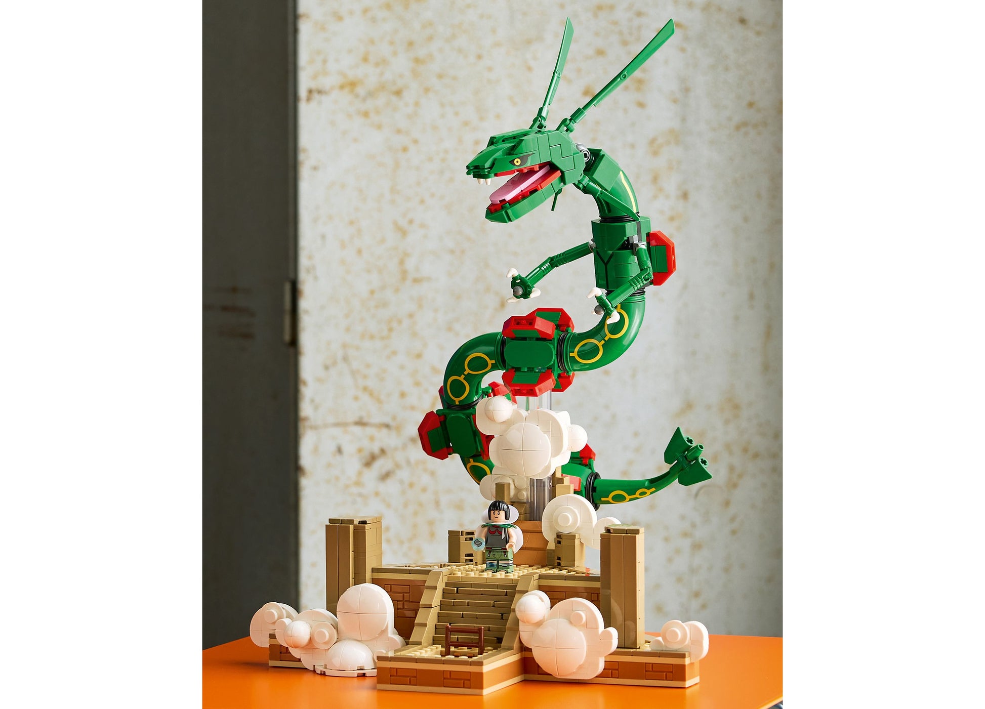 LEGO Pokémon Rayquaza green posable dragon figure with red accents on wooden base display set