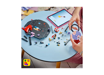 LEGO Olivia Rodrigo's Vinyl 43028 building set with colorful pieces, minifigure, and pink tablet on blue table