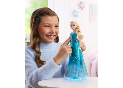Girl holding Disney Princess Singing Elsa 11" Light-Up Fashion Doll in blue dress with blonde hair