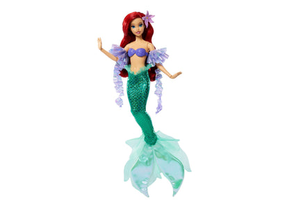 Disney Princess Ariel doll with red hair, purple flower clip, blue top, green sequined tail, and purple ruffled sleeves