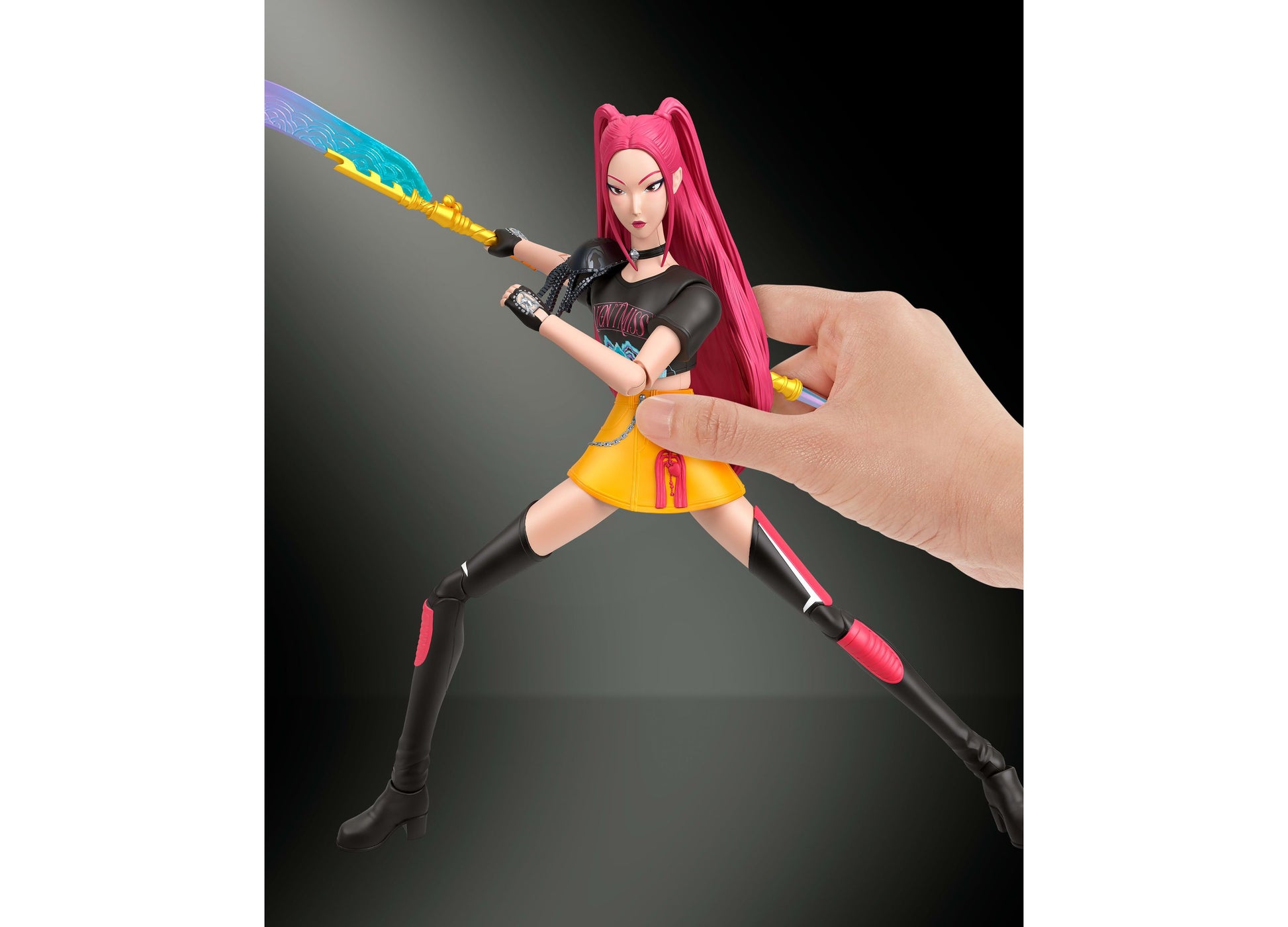 Huntrx Mira 6-inch action figure with pink hair, black outfit, yellow skirt, and blue energy sword