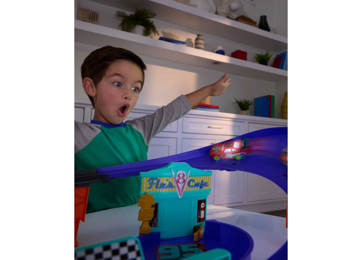 Cars Lightning McQueen Light-Up Celebration Raceway playset with blue track and Flo's Cafe building